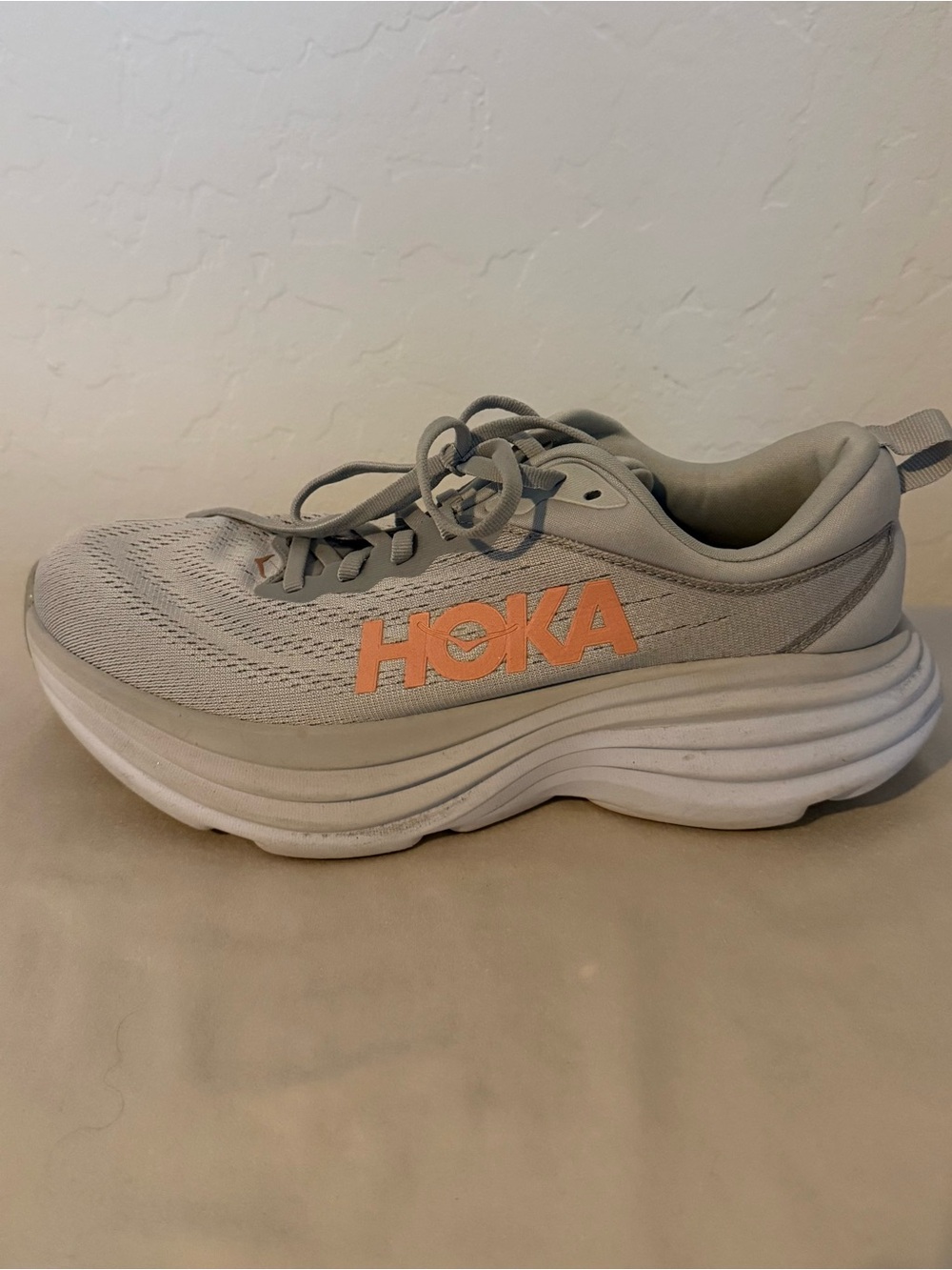 Hoka Women’s Running Shoe in Light Gray with Coral Logo